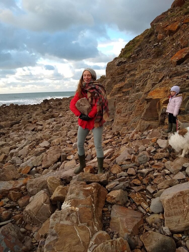 Laura on Morwenna's beach, holding a stone