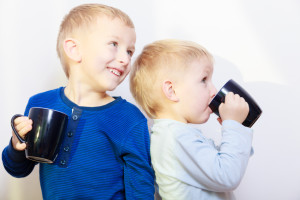Happy childhood. Two brothers little boys drinking tea